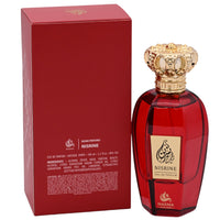 Red Nisrine perfume bottle with gold cap and packaging on a white background
