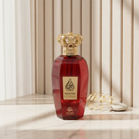 Red perfume bottle with gold cap on a white background